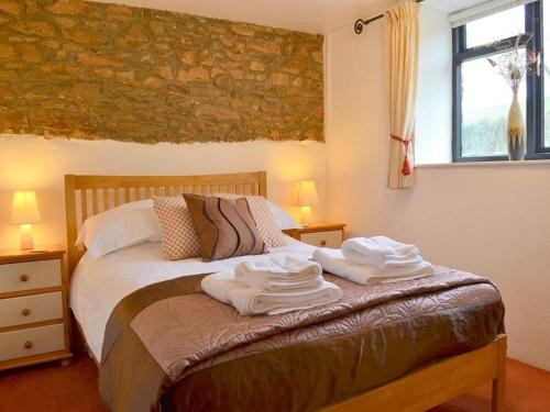 a bedroom with a bed with towels on it at Kingfisher Cottage at Robin Hill 4 in Bideford