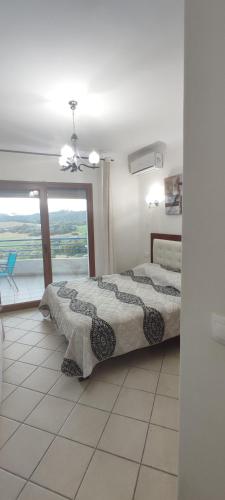 a bedroom with a bed and a large window at Appartement hôtel cabo dream in Cabo Negro