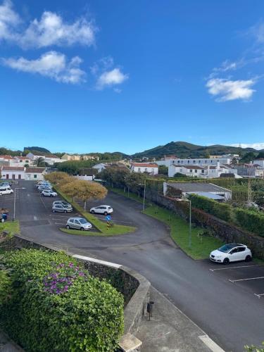 a street with cars parked in a parking lot at Lugar d ribeira in Lagoa