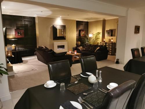 a living room with a dining table and a living room at Glangwili Mansion - Luxury 5 star Bed & Breakfast in Carmarthen