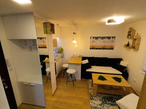 a living room with a couch and a table at Acero Verde Jahorina in Jahorina