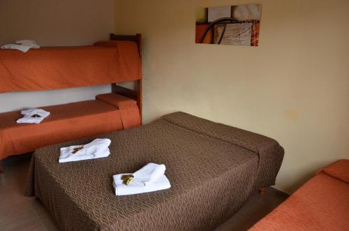 Dos camas en una habitación de hotel con toallas. en Hostal Solar de Piedras in 