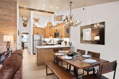 a kitchen and dining room with a table and a couch at Terracehouse by Snowmass Vacations in Snowmass Village
