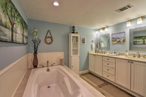 a large bathroom with a tub and two sinks at Palmetto Dunes Villa with Lagoon and Fountain Views in Hilton Head Island