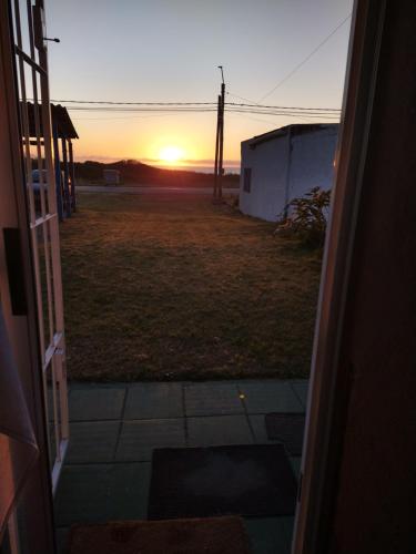 a view of a sunset from the door of a house at Mar in La Paloma