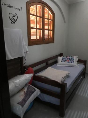 a bedroom with two beds and a window at Casa com Piscina Canto do Forte - Praia Grande in Praia Grande