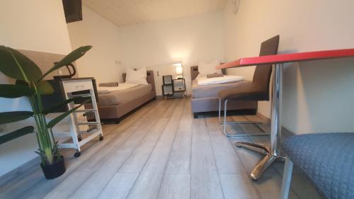a room with a couch and a bed and a table at Neuburg Apartment am Schloss in Neuburg an der Donau