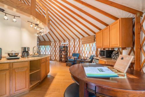 una cocina con armarios de madera y una mesa en una habitación en Strawhouse Resorts en Big Bar