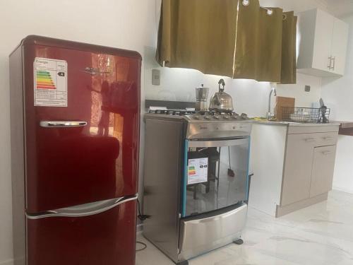 a kitchen with a stove and a refrigerator at La Mar Box 7 frente al Mar - Parejas in Pichilemu