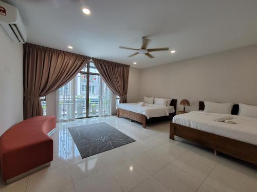 a bedroom with two beds and a ceiling fan at Malacca City Center Town House by 360HOME in Melaka