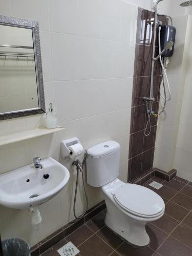 a bathroom with a toilet and a sink at Malacca City Center Town House by 360HOME in Melaka
