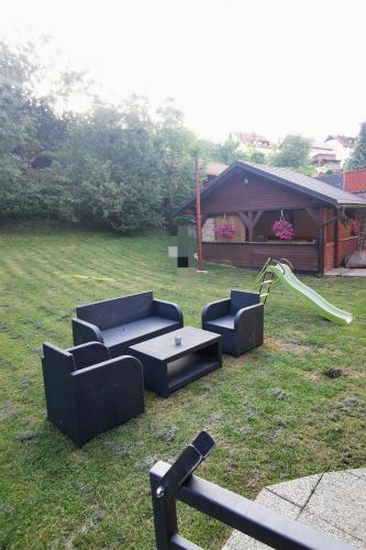 two couches and a table in a yard at Apartments with a parking space Delnice, Gorski kotar - 20247 in Delnice