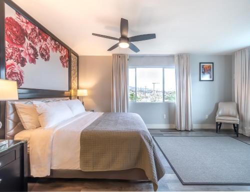 a bedroom with a bed and a ceiling fan at Onsen Hotel and Spa in Desert Hot Springs