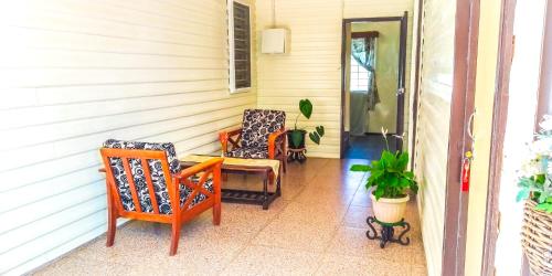 two chairs and a table on a porch at Shalom Mission Home in Mount Hagen