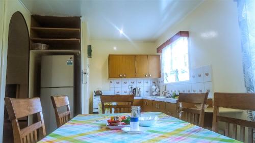 a kitchen with a table with a bowl of fruit on it at Shalom Mission Home in Mount Hagen
