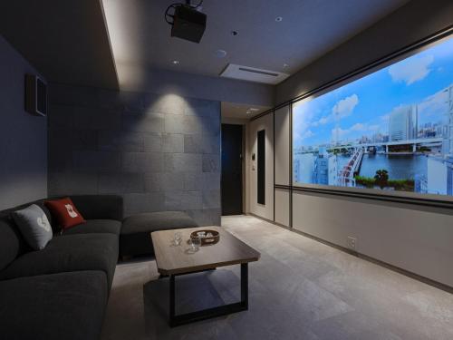 a living room with a large flat screen tv at MIMARU SUITES Tokyo ASAKUSA in Tokyo
