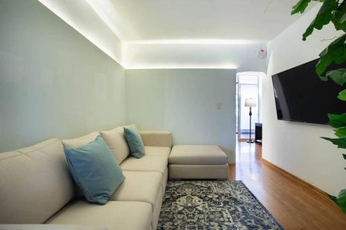 sala de estar con sofá y TV de pantalla plana en Habitación privada c/ terraza &escritorio Polanco., en Ciudad de México