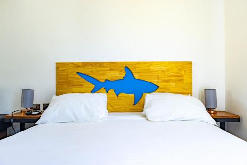 a bedroom with a bed with a shark headboard at Shark Town Mal Pais in Santa Teresa Beach
