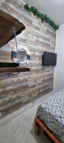 a bedroom with a wall made out of wood at Casa Hostel San Andres in San Andrés