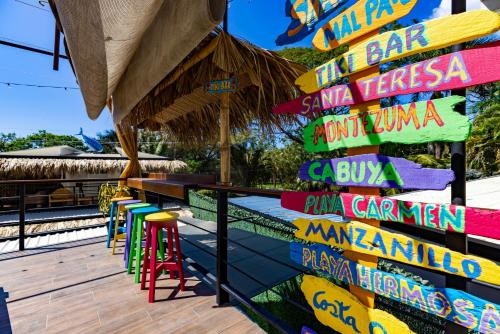 a colorful sign on the deck of a restaurant at Shark Town Mal Pais in Santa Teresa Beach