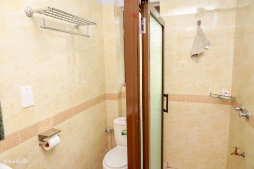 a bathroom with a toilet and a shower stall at Luxe Furnished Apartments Unit 9 in Meru