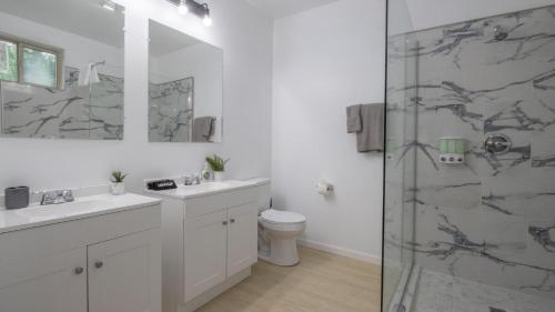 a bathroom with two sinks and a shower at Vibrant Blue Luxury Loft 2316 in New Orleans