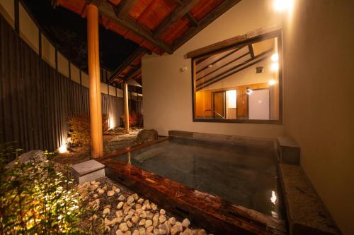 a swimming pool in the middle of a house at Glamping Villa Hanz Kawaguchiko in Fujikawaguchiko