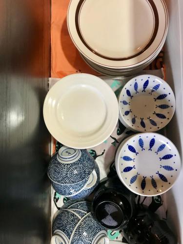 a drawer filled with blue and white plates and bowls at Ishimaru House in Seki