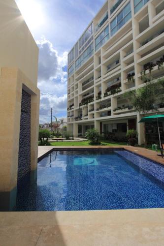 a swimming pool in front of a building at Mesón de la Luna Hotel & Spa in Mérida