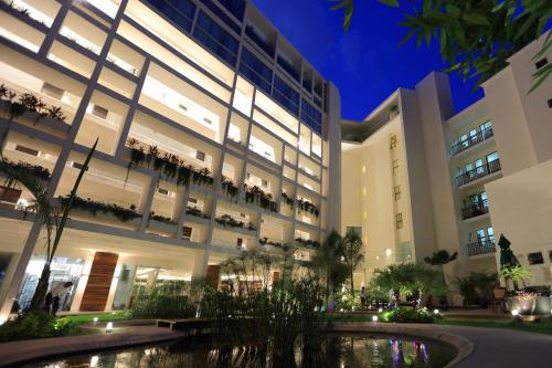 a large building with a pond in front of it at Mesón de la Luna Hotel & Spa in Mérida