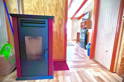 a colorful refrigerator in a room with a hallway at Acogedor departamento interior, a minutos del Lago in Llanquihue