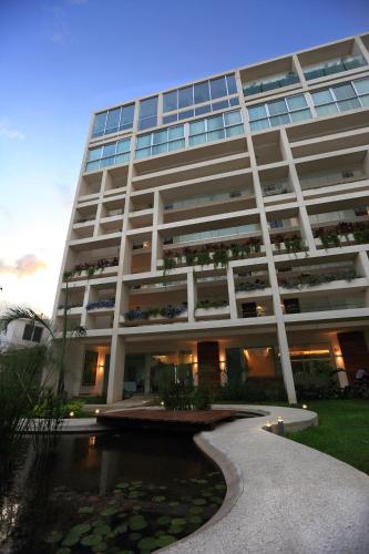 a large building with a pond in front of it at Mesón de la Luna Hotel & Spa in Mérida
