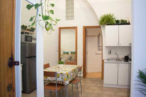 a kitchen and dining room with a table and chairs at La Casetta in Catania