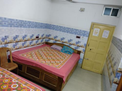 Postel nebo postele na pokoji v ubytování Jagannath Guest House
