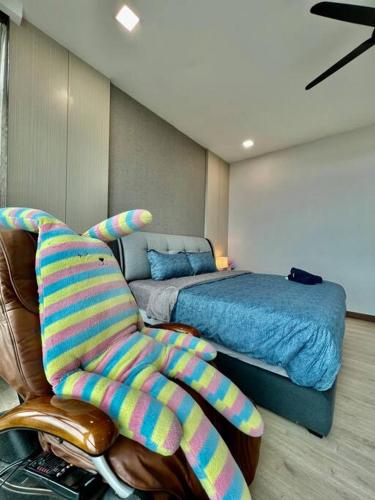 a bedroom with a bed and a chair and a couch at A2801 Green Haven 4Bedroom netflix100mbps By STAY in Masai