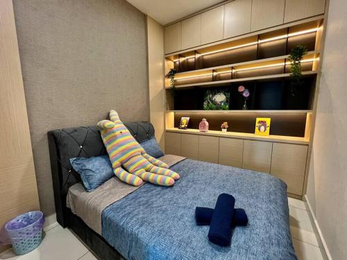 a bedroom with a bed with two blueippers on it at A2801 Green Haven 4Bedroom netflix100mbps By STAY in Masai