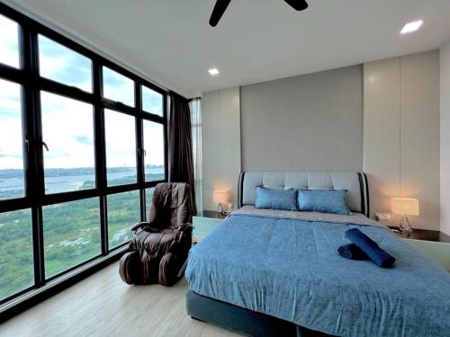 a bedroom with a bed and a chair and large windows at A2801 Green Haven 4Bedroom netflix100mbps By STAY in Masai