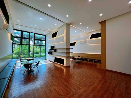 a large living room with a table and a large window at A2801 Green Haven 4Bedroom netflix100mbps By STAY in Masai