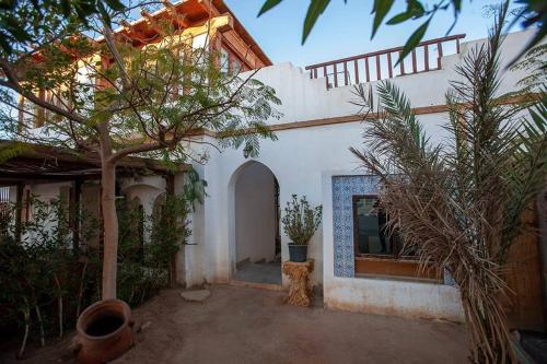 a white house with a cat sitting in front of it at Abouseif Guest House in Sharm El Sheikh