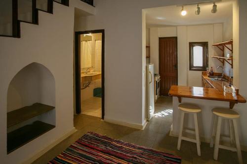 a kitchen with a table and two stools and a dining room at Abouseif Guest House in Sharm El Sheikh