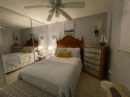 a bedroom with two beds and a ceiling fan at Jewel of the East in Ceiba
