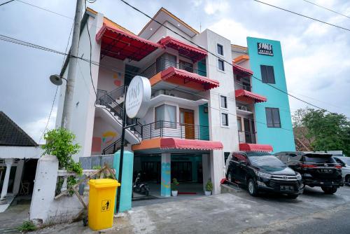 a building with a car parked in front of it at Sans Bougenville Lampung in Lampung