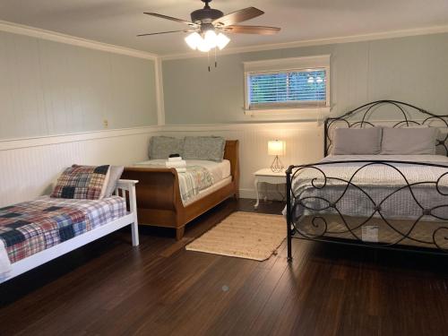 a bedroom with two beds and a ceiling fan at Tucked Away Newly Renovated 2 Bedroom/ 1 Bath Sleeps 8 in Beaufort