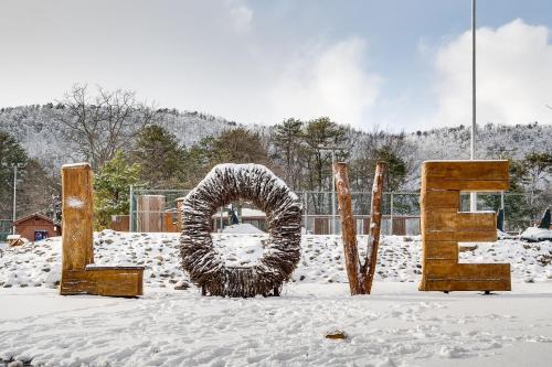 a snow covered sign that says love in the snow at Mt Views - Sauna - Hot Tub - Adulting - Family Fun in Massanutten