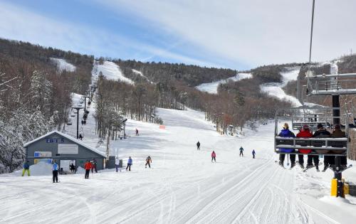 a group of people skiing down a ski slope at Mt Views - Sauna - Hot Tub - Adulting - Family Fun in Massanutten