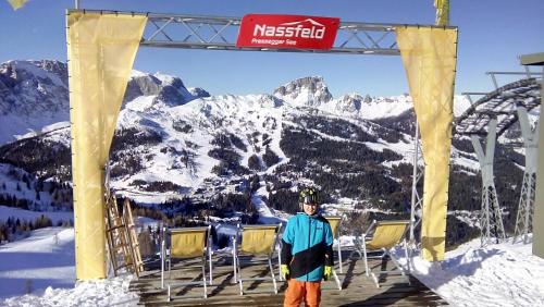 a man standing on a ski lift in the mountains at Ferienhof Alte Post, Apartments in Weissbriach