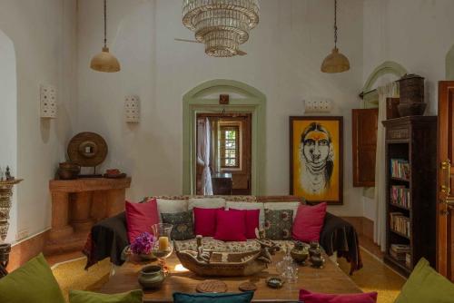 a living room with a couch and a table at Turia Villa Canacona Palolem in Canacona