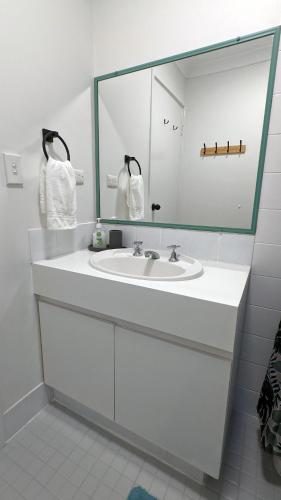 a bathroom with a sink and a large mirror at Relaxing Home Close to Nature in Bunbury