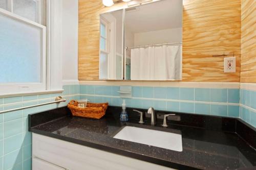 a bathroom with a sink and a mirror at Chevy Chase 3 BR Chic Comfortable Spacious Luxury in Washington, D.C.