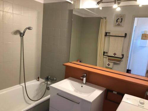 une salle de bain avec un lavabo, une douche et un miroir dans l'établissement Appt T3 avec terrasse, clim, parking à Cap d'Agde, proche plage et commerces - FR-1-249-38, au Cap d'Agde